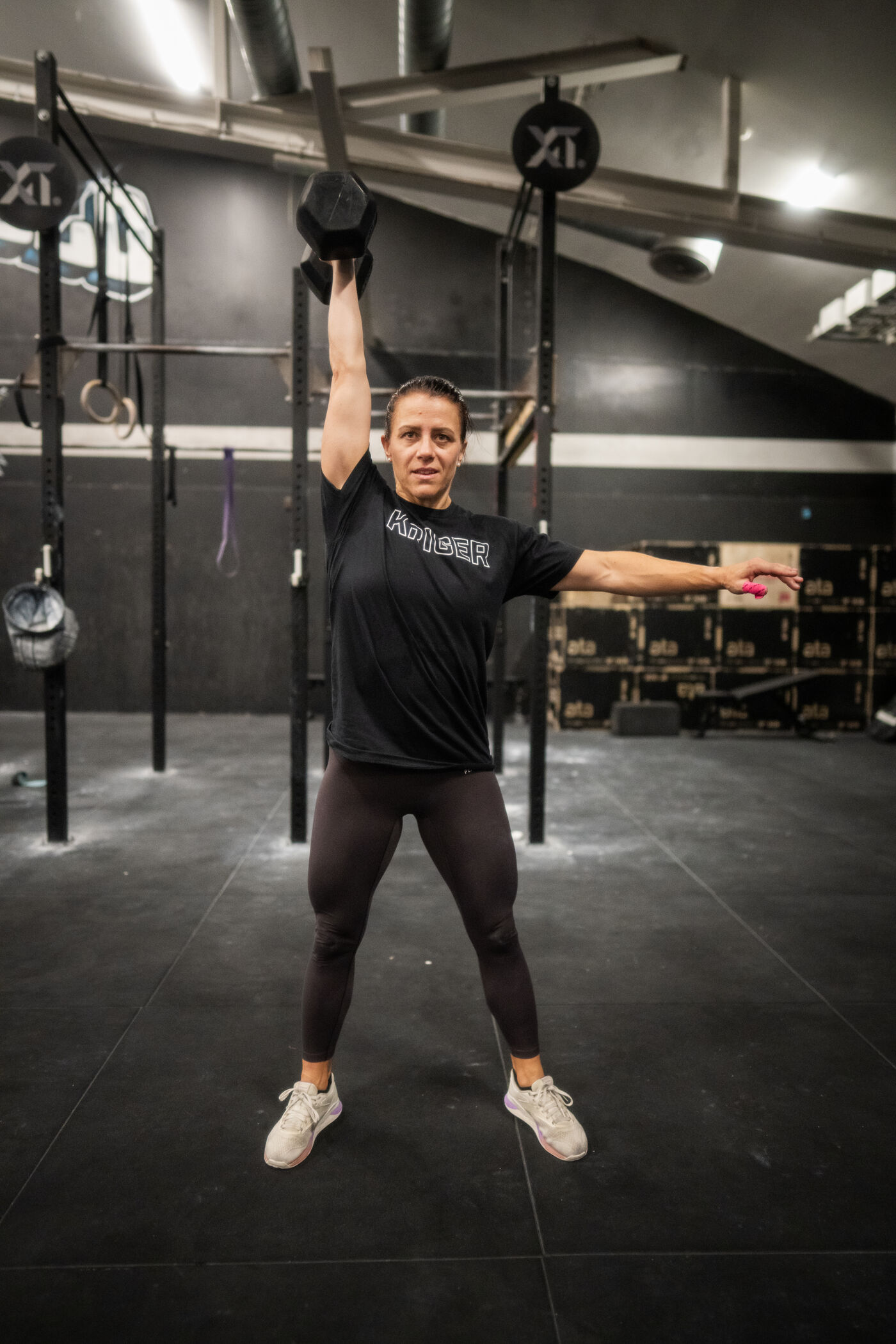 Athlete kettlebell overhead at gym