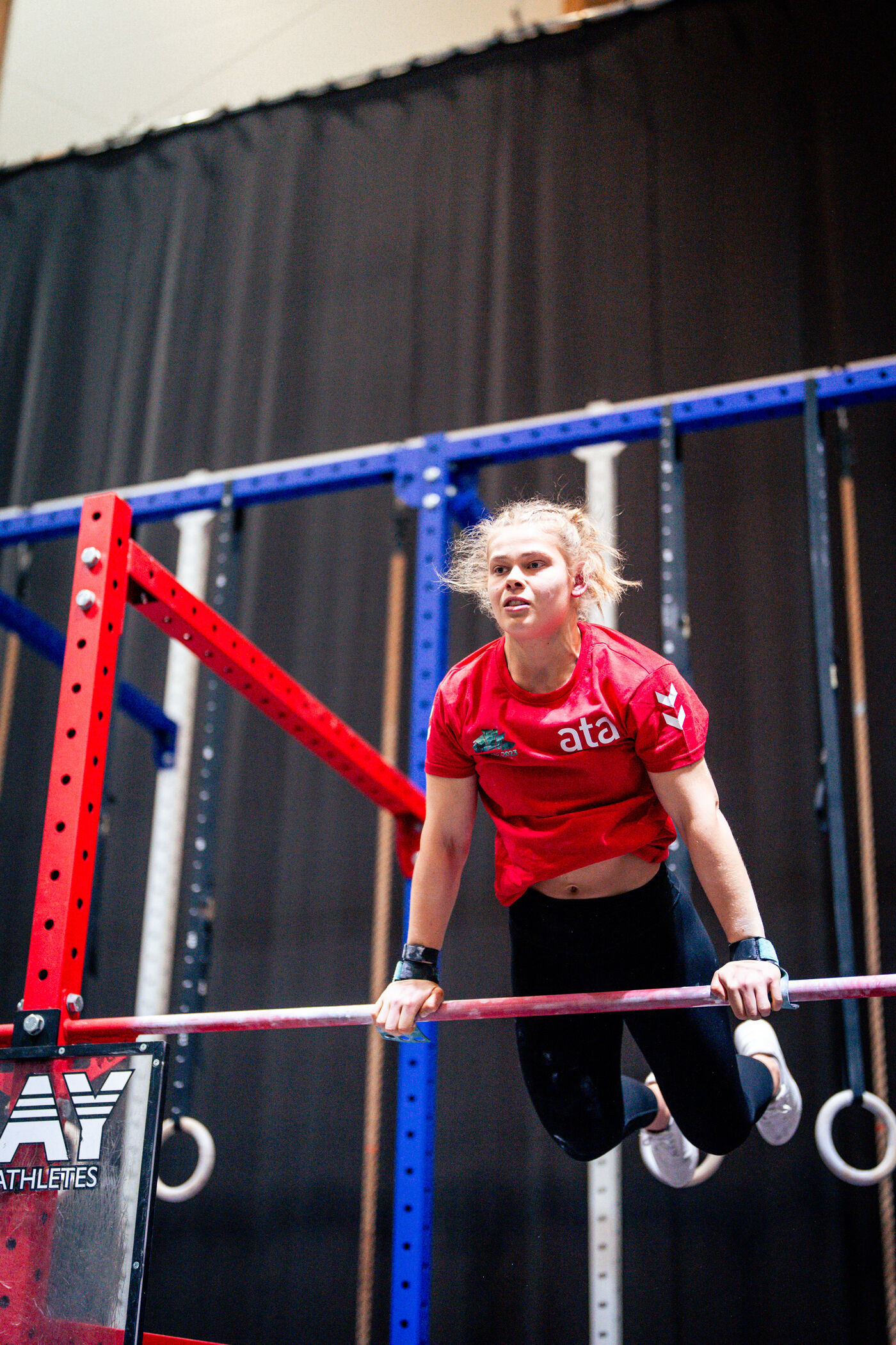 Athlete bar muscle-up at competition